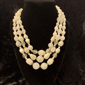 An Antique Milk Bead Triple Strand Statement Necklace